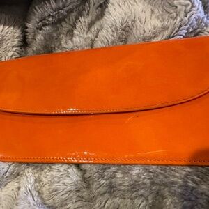 Graphic image orange leather clutch